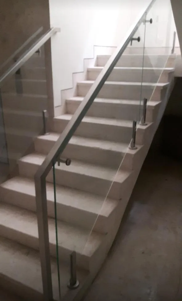 Glass staircase railing with stainless steel handrail