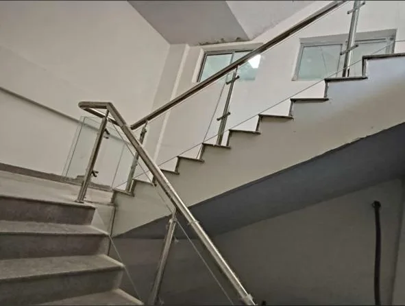 Staircase railing with glass and stainless steel handrail
