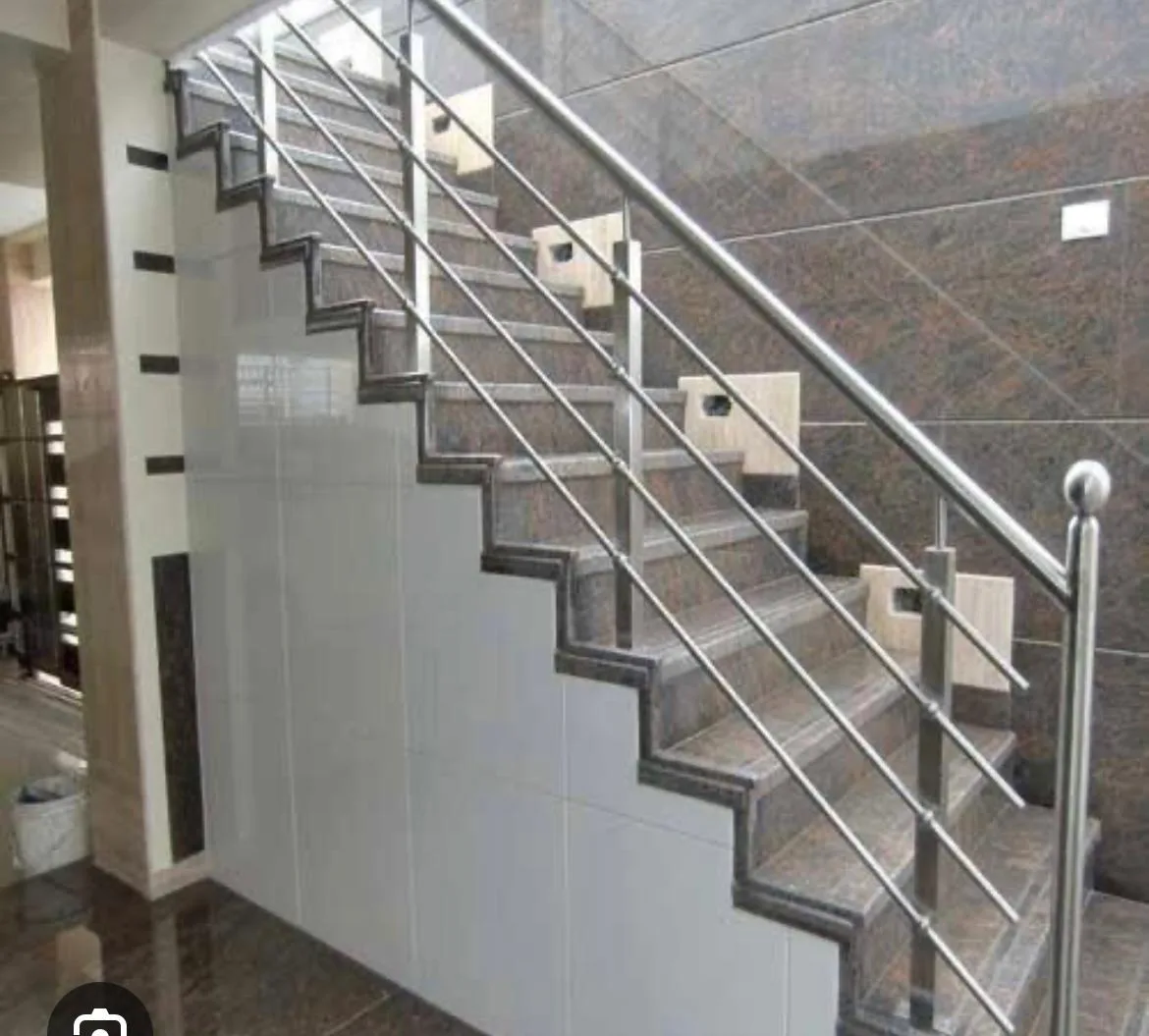 Stainless steel rod railing on a tiled staircase