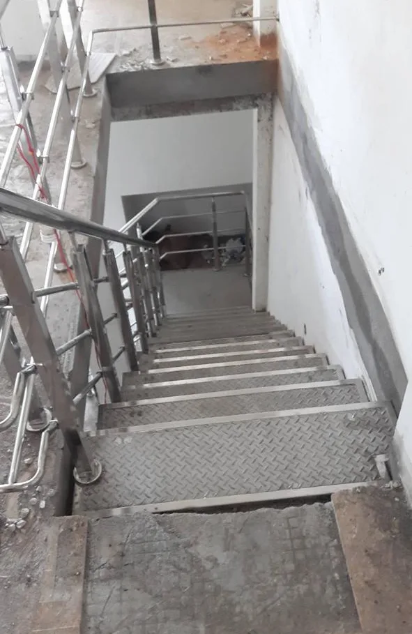 Steel staircase with perforated treads and side railing